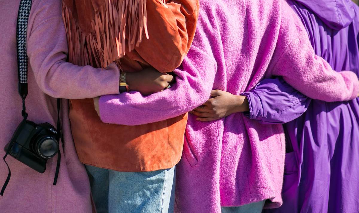 colorful shot of people hugging.