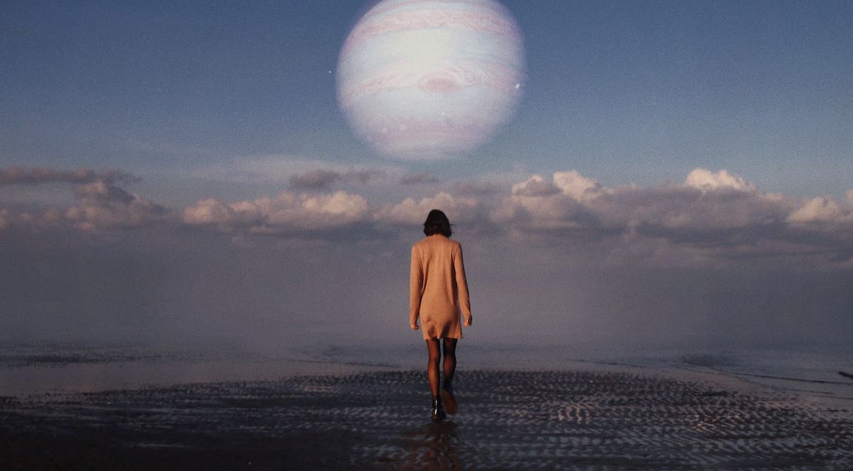 surreal photography featuring a woman and a planet.