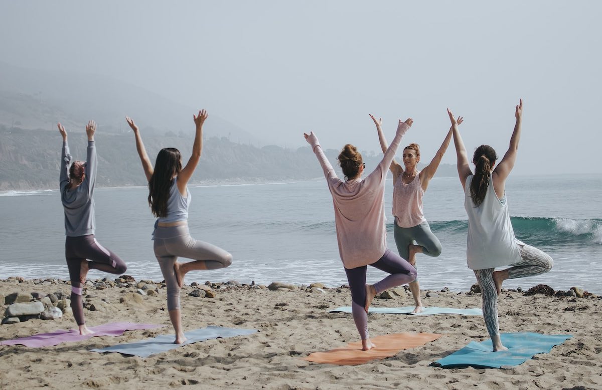 women practicing self-care outdoors.