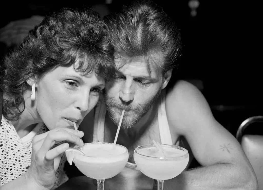 Fine art portrait of a couple sharing drinks. Touching, romantic moment caught in an authentic close-up portrait.