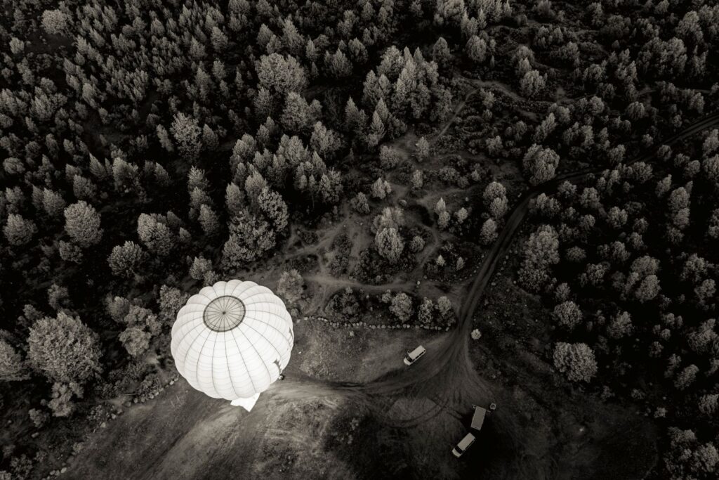A black and white image of a hot air balloon about to take off.