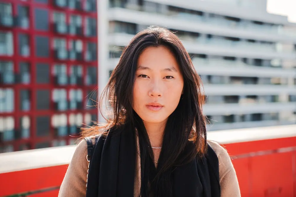 Portrait of young woman in color. Street portrait in urban environment.