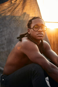 A sunset portrait of a shirtless man by Nick Wong.
