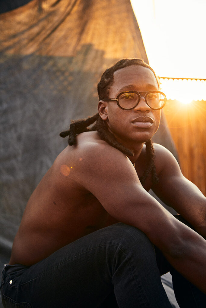 A sunset portrait of a shirtless man by Nick Wong.