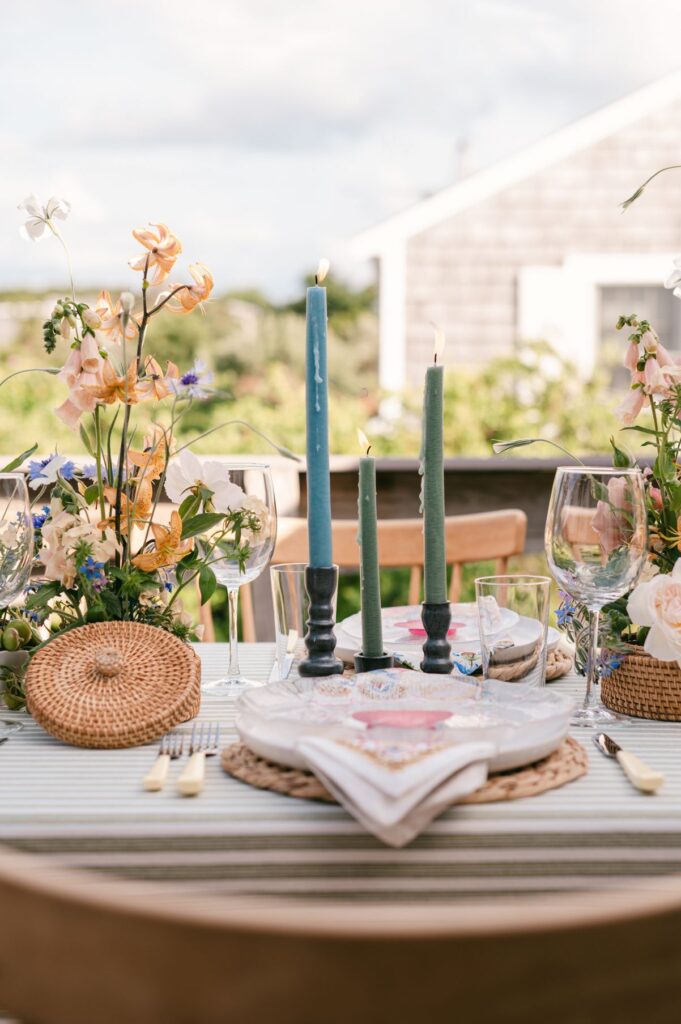 An image of a wedding table setup with candles and utensils by Shannon Grant.