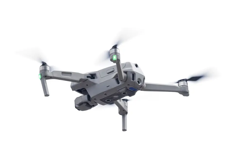 Close-up shot of a UAV in flight. Quadrotor aircraft with on-board camera in the air, shot from below.
