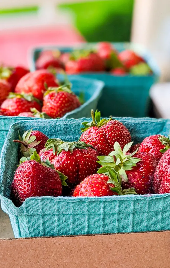Close-up of fresh strawberries in portrait mode.