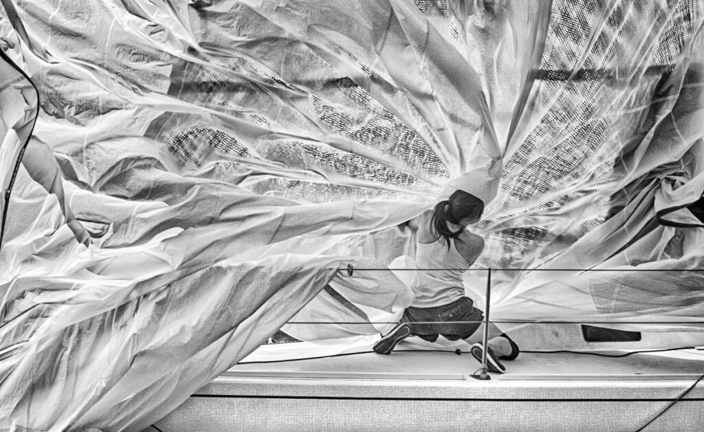 An image of a woman manipulating some sails by Daniel Forster.