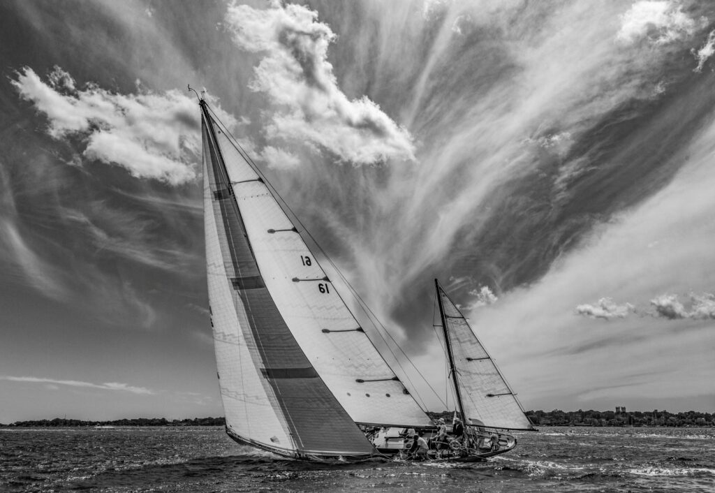 A black and white image of a sailboat racing under a dramatic sky by Daniel Forster.