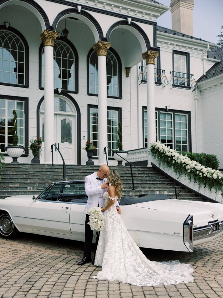 An image of a wedding couple standing out front of a car after the ceremony by Hannah Bjorndal.