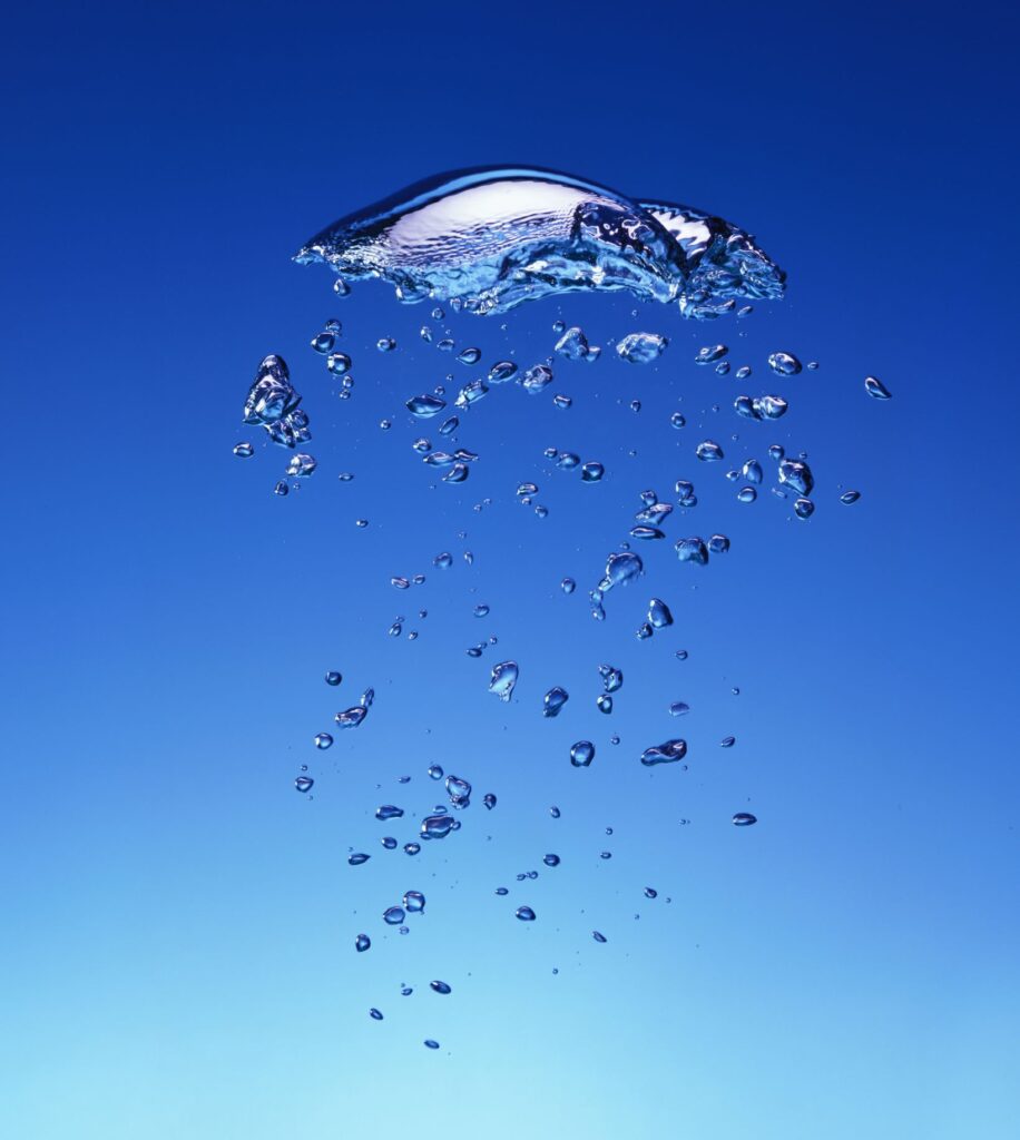An image of oxygen rising in some water by Jonathan Knowles.