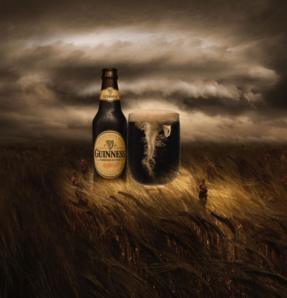 An image of some Guinness beer in the middle of a field in what looks like a windy tornado.