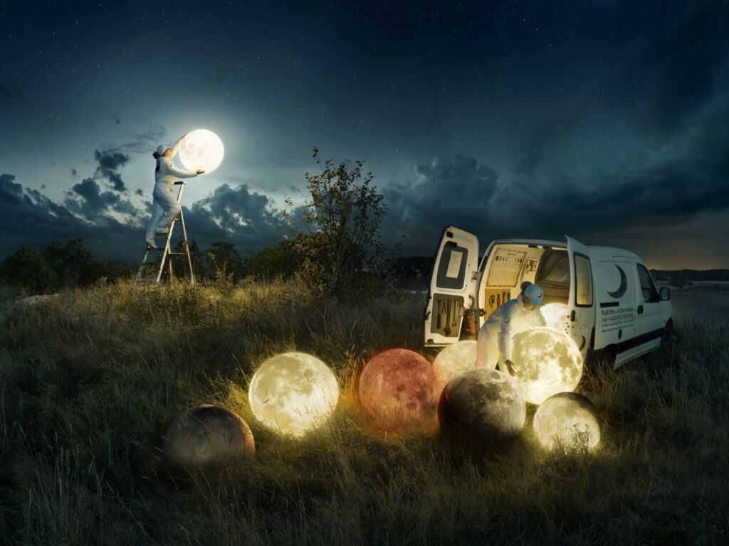 A surreal image of moons spilling out of a van while someone in the background changes the moon like a lightbulb by Erik Johansson.