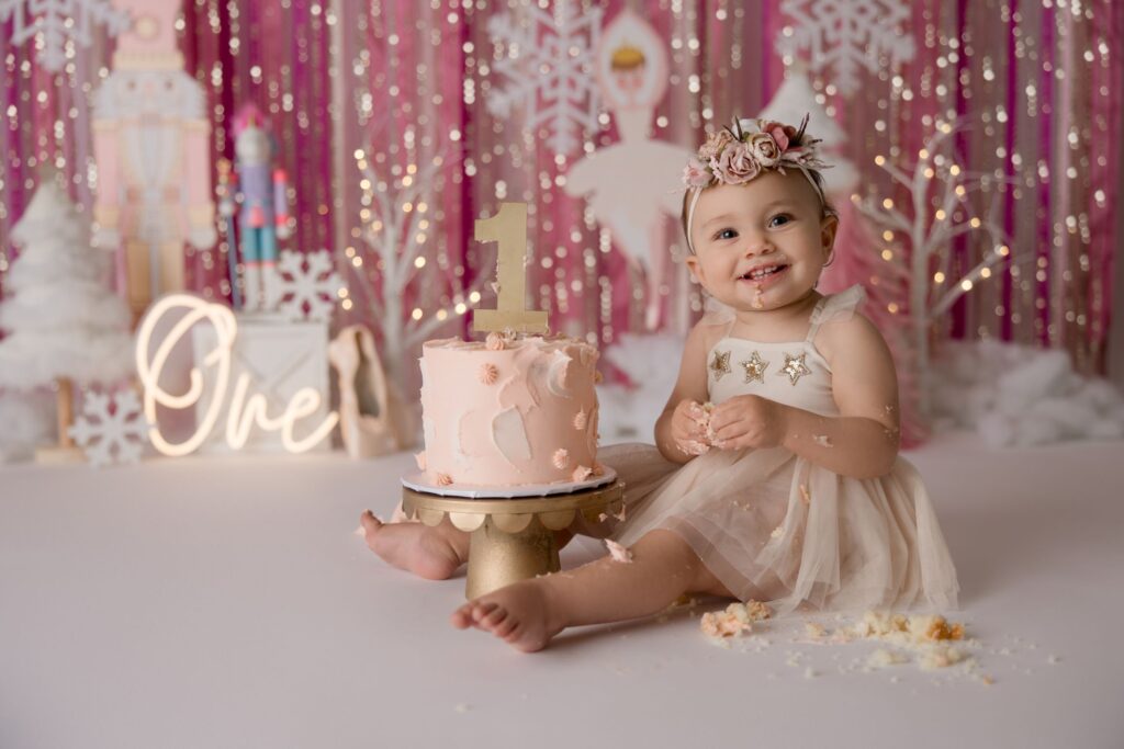 An image of a toddler next to a cake, photographed by Kristeen Waddell.