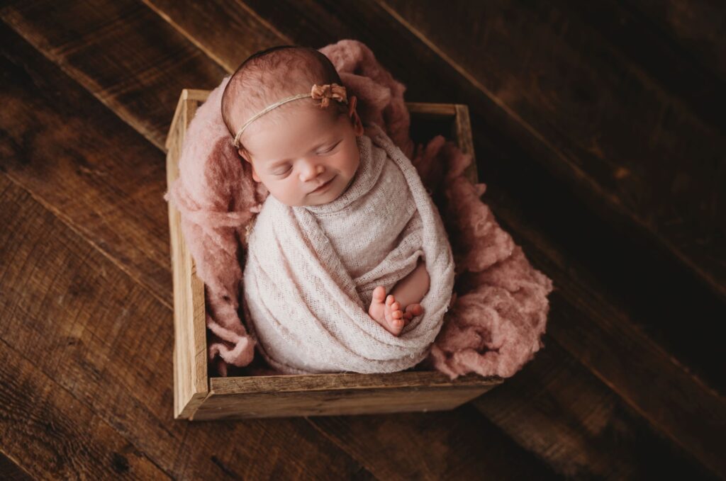 An image of a newborn photographed from above. 