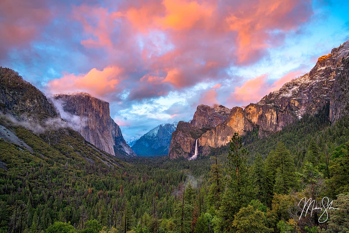 Colorful sunset clouds over Yosemite Valley with El Capitan and Bridalveil Fall.
