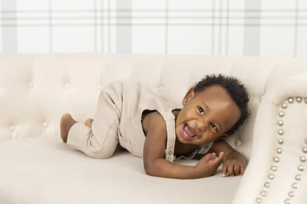 An image of a toddler being playful on a couch by Brittany DeMaio.
