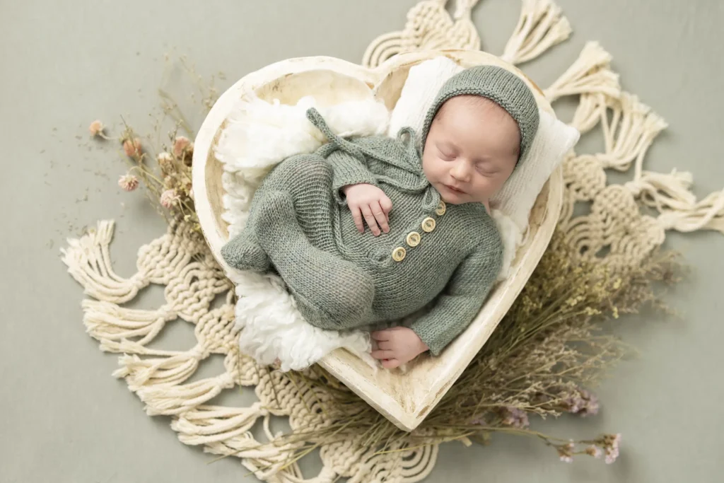 An image of an infant in a heart shaped basket photographed by Brittany DeMaio.