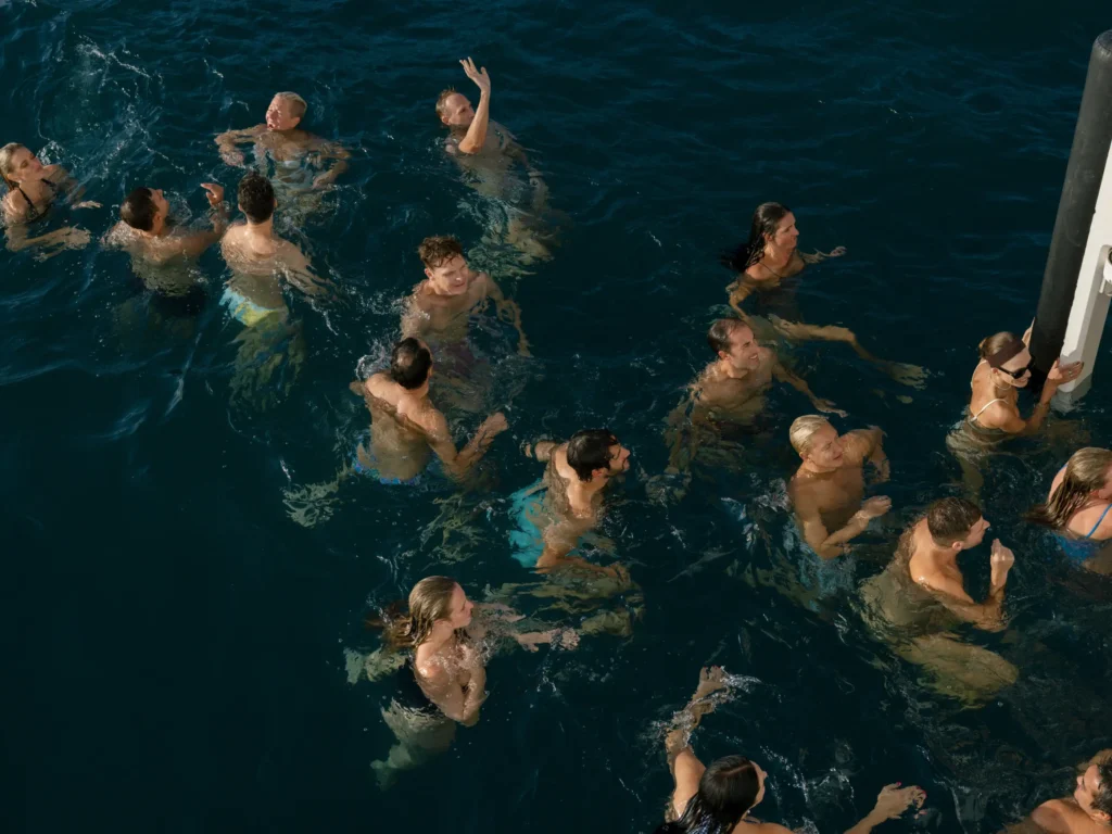 A photograph of people enjoying a party while swimming by Erich McVey.