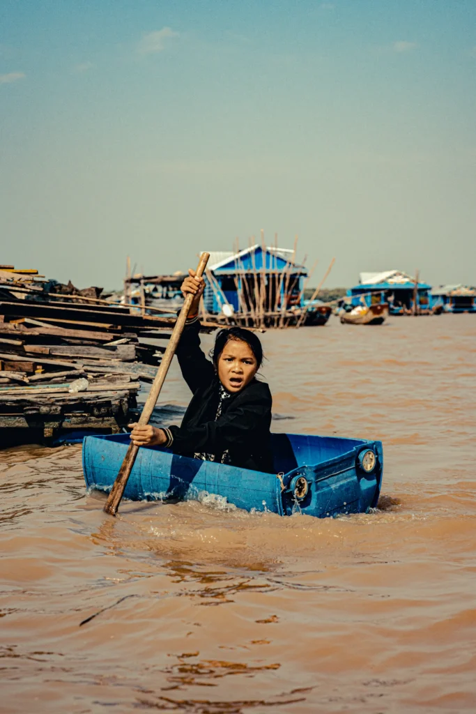 An image of a woman paddling a makeshift rafter by Paulie Marechal.