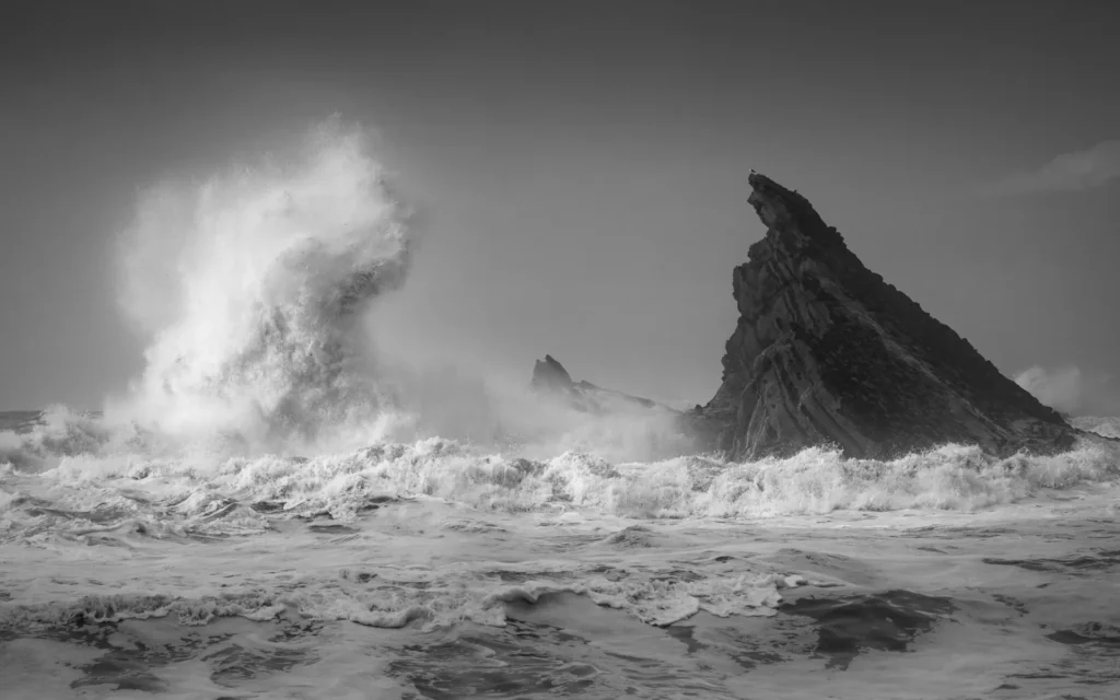 An image of a wave with ground jutting from the water by Rachael Talibart.