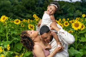 An image of a family in a field of sunflowers by Victor Coker Jr.