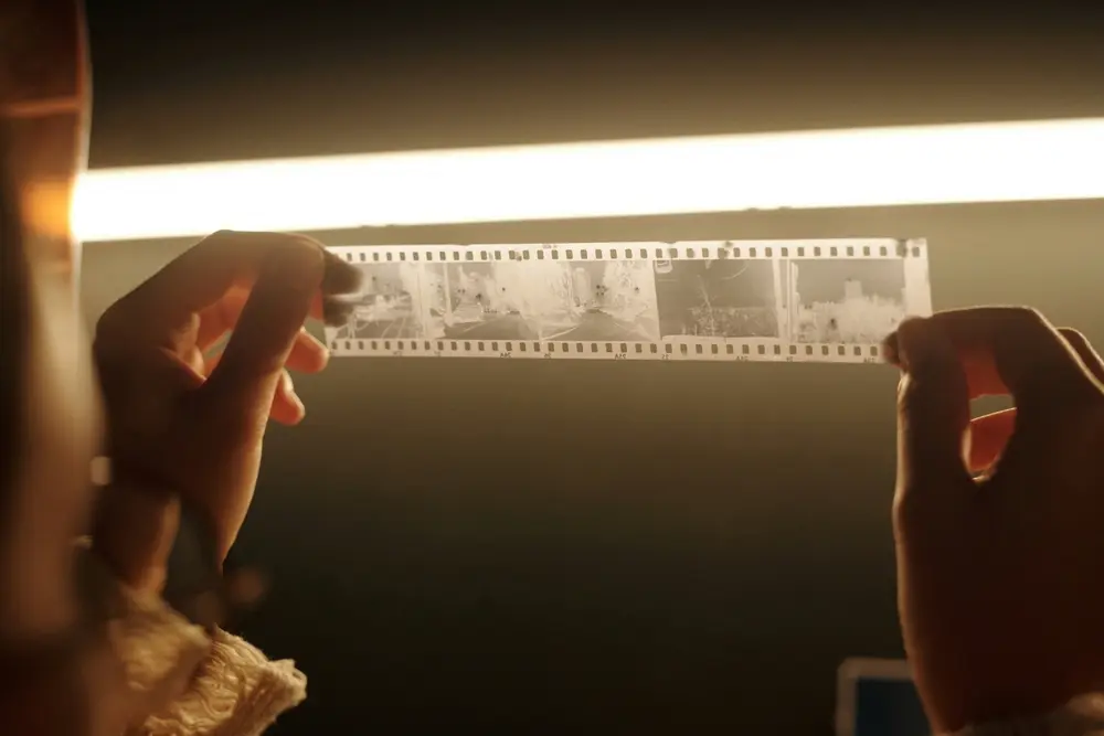 Person holding a film negative.