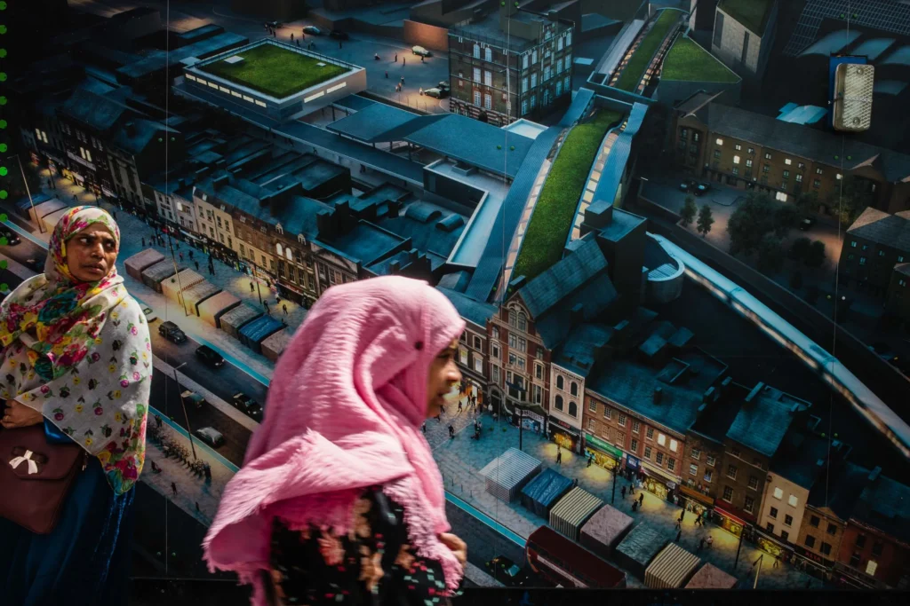 An image of two women looking down at a cityscape by Ben Smith