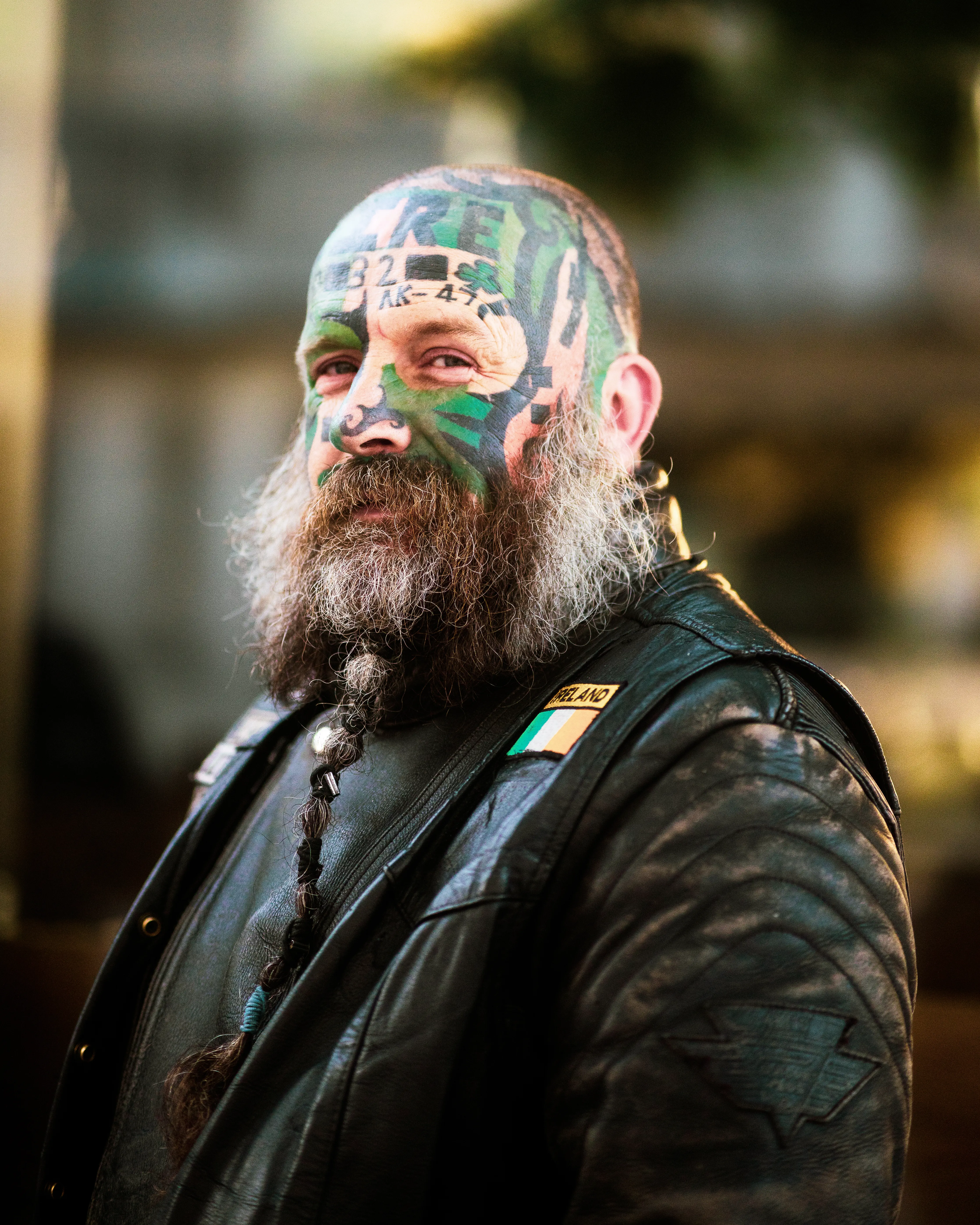 Portrait of a tattooed man with a long beard wearing a leather jacket in Cork City, Ireland.