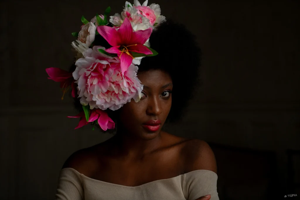 A photograph of an African American model with a beautiful bonnet of flowers by Ivan Tsupka.