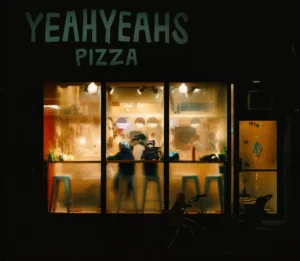 A photograph of a pizza restaurant in winter by Thomas Luscombe.