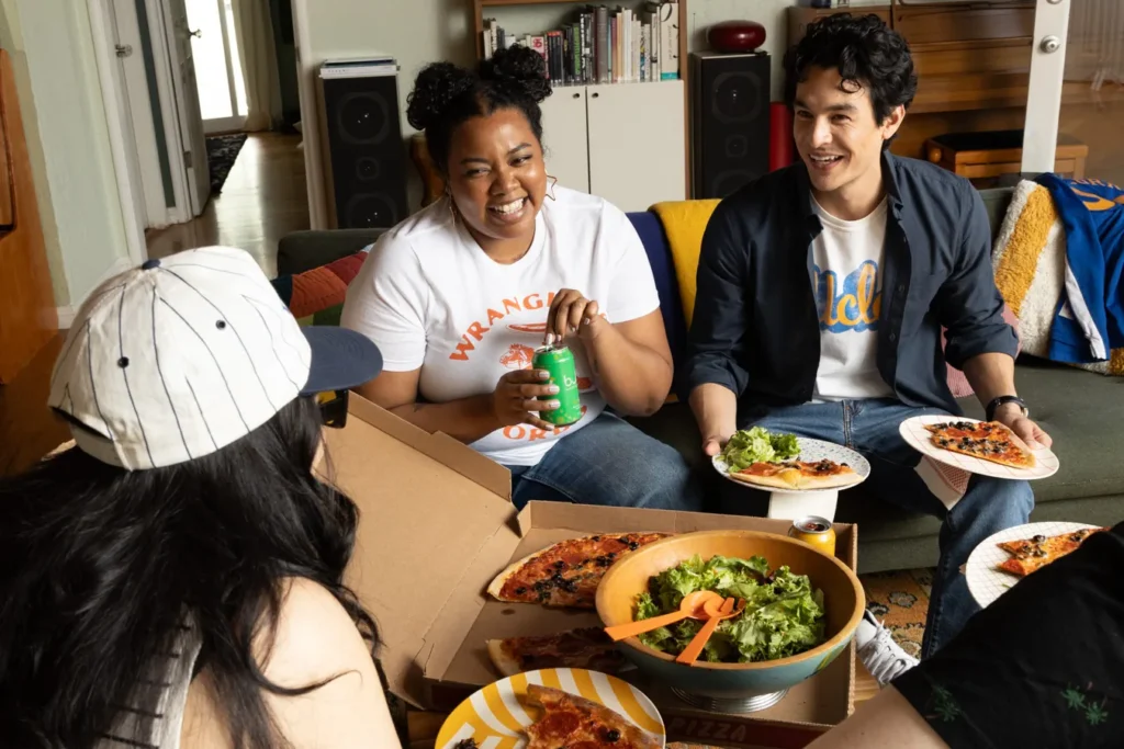 A photograph of some friends sitting around eating a meal by Shelly Waldman.
