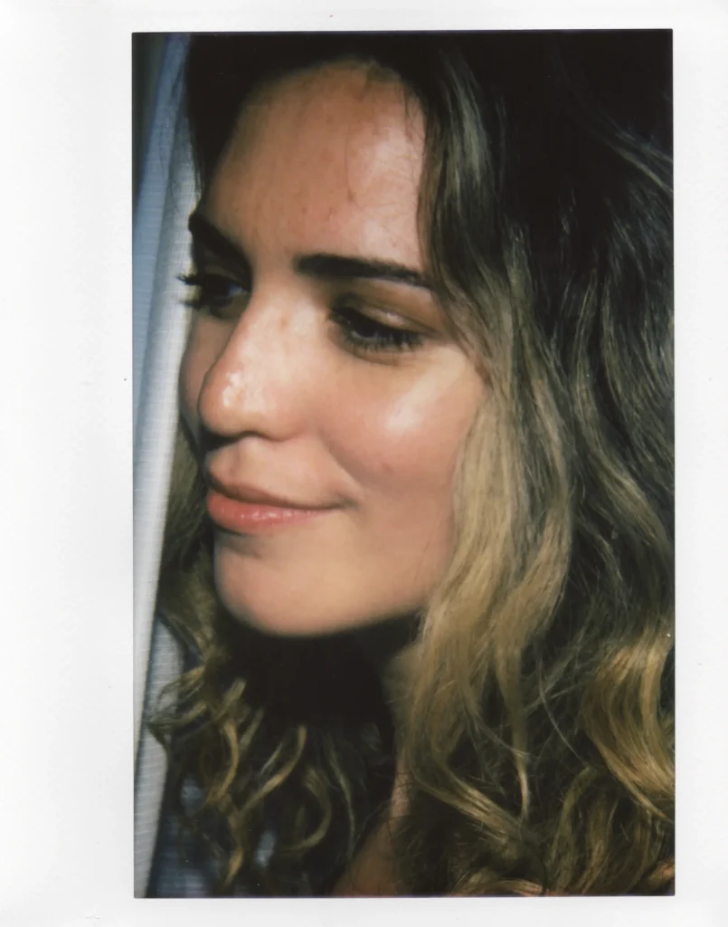 A polaroid scan of a woman looking off to the side by Alin Tolea.
