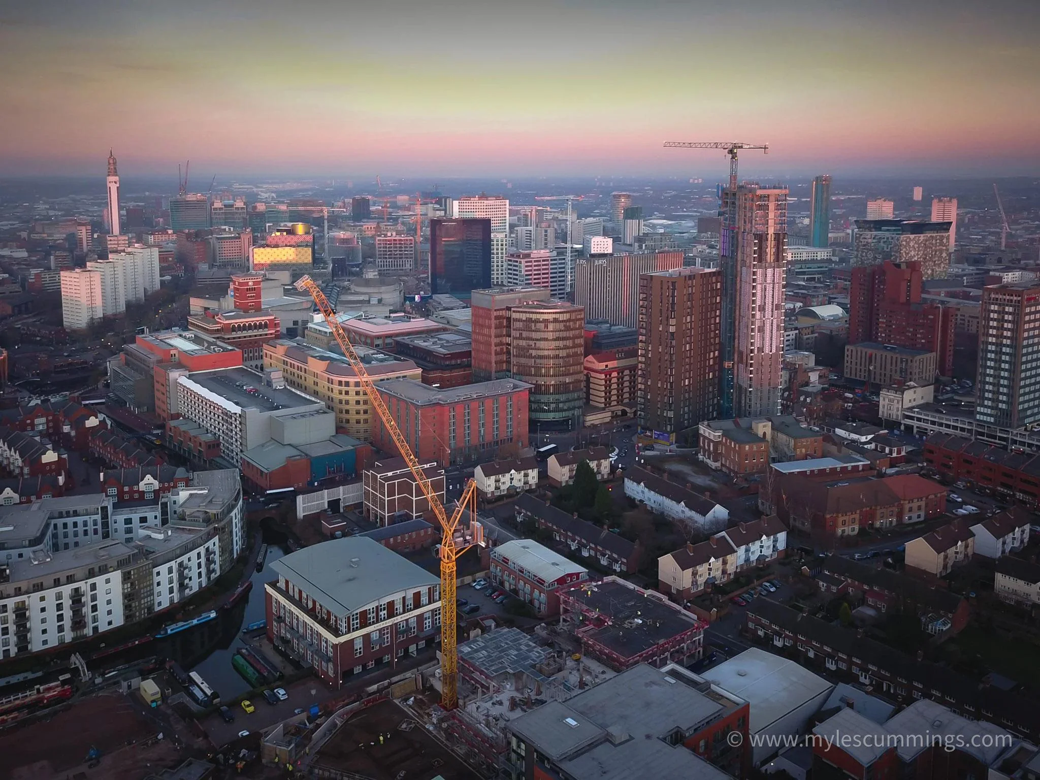 Hazy aerial cityscape at dusk in golden light