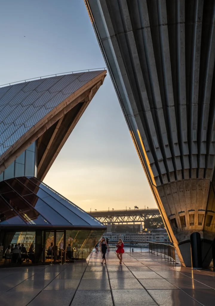 An image of two people walking through a plaza by Ronan O'Connell
