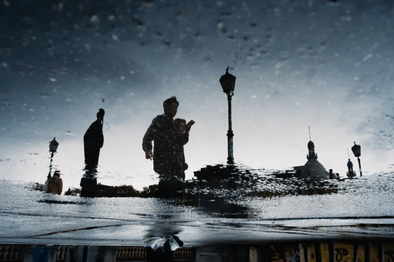 A street photography image of a reflection in a puddle by Frederic Paulussen
