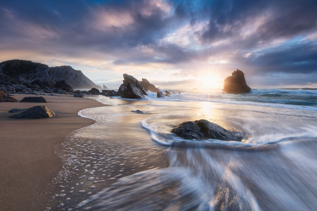 A long exposure shot of a shoreline by Michael Breitung.