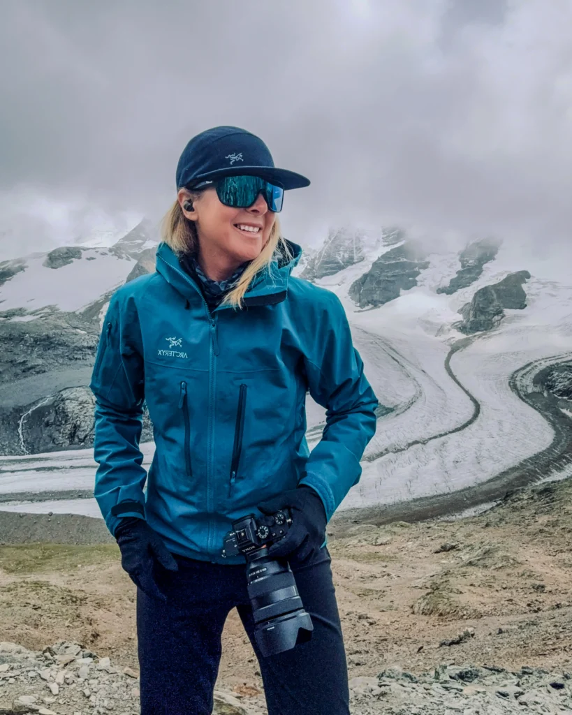 A portrait image of photographer Alexandra Nemeth holding her camera.